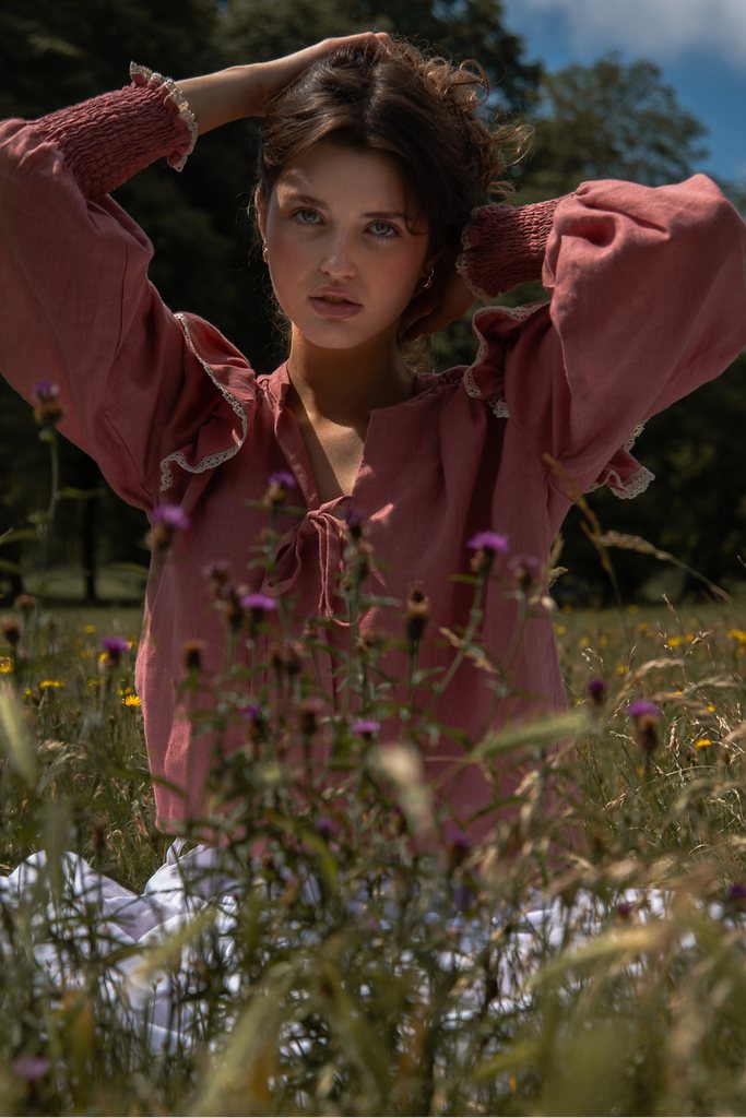 Editorial fashion portrait in pink among wildflowers photographed by Lucy Rappolt