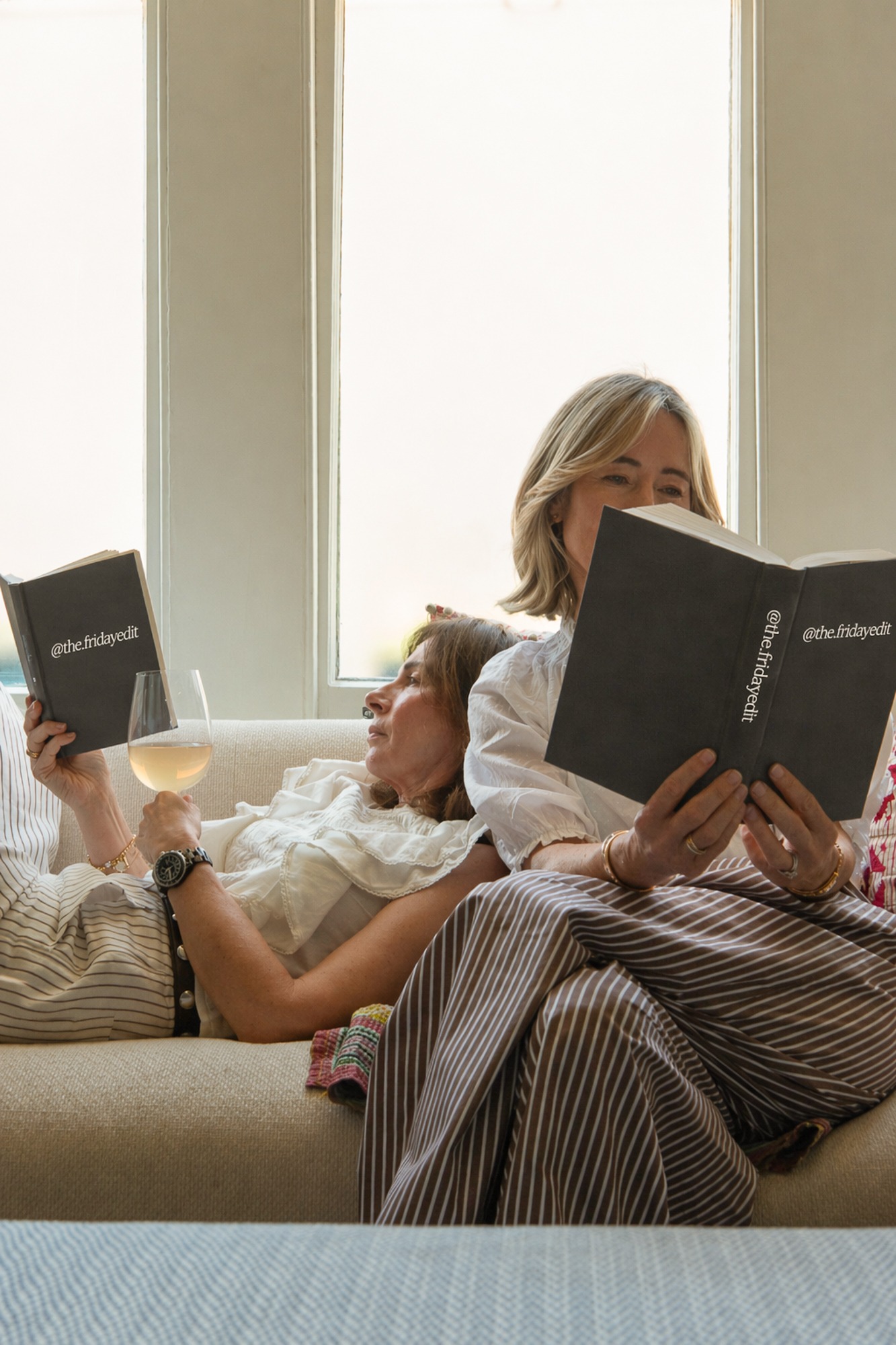 Relaxed editorial portrait of two women reading